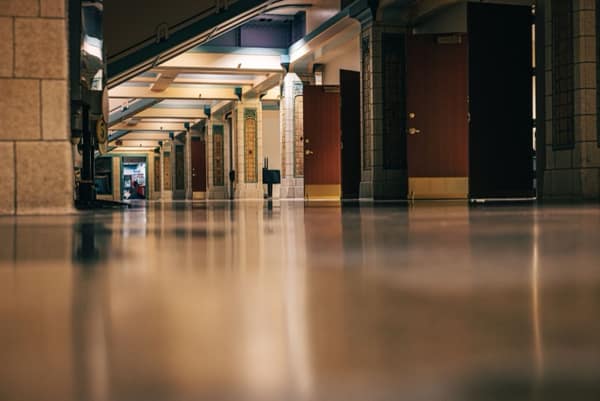 A polished hard floor running the length of a building corridor