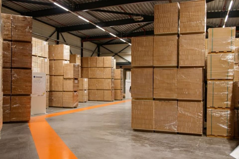 Stacked cardboard cartons on pallets in a warehouse