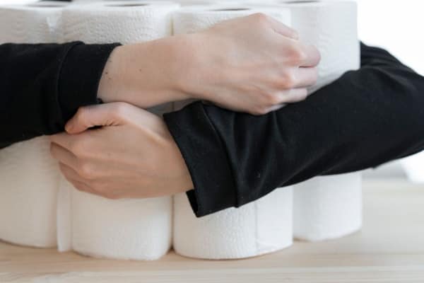 An armful of paper roll stock