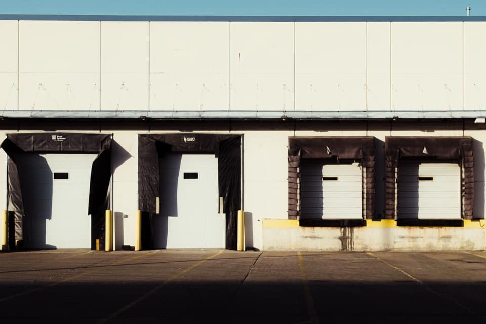 An industrial loading dock with closed bay doors