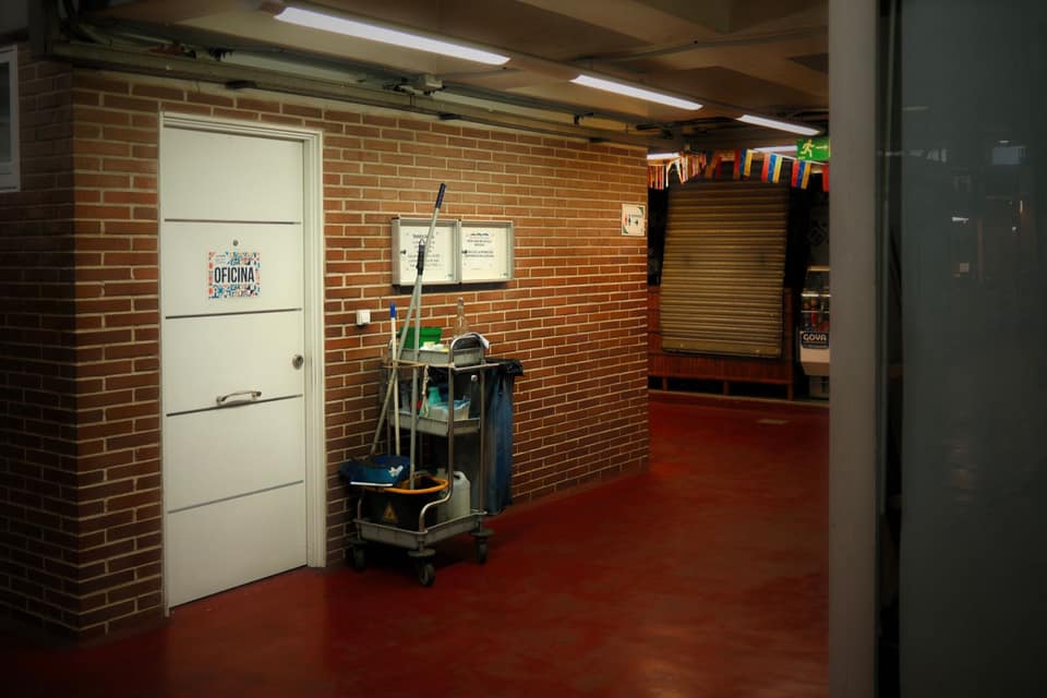 A stocked cleaning cart in a building corridor