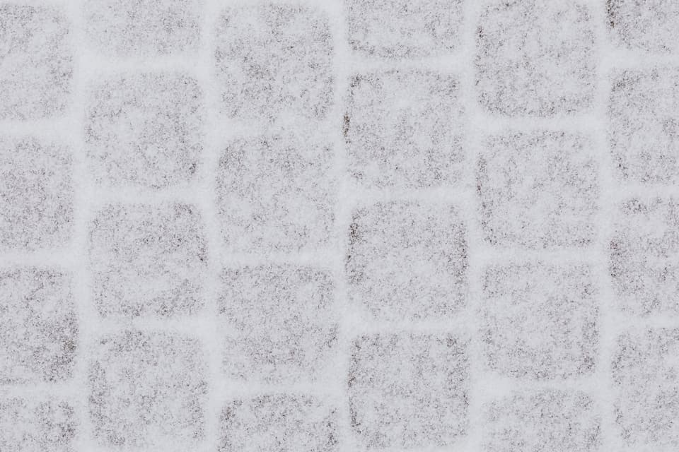 A paved path covered in trodden snow